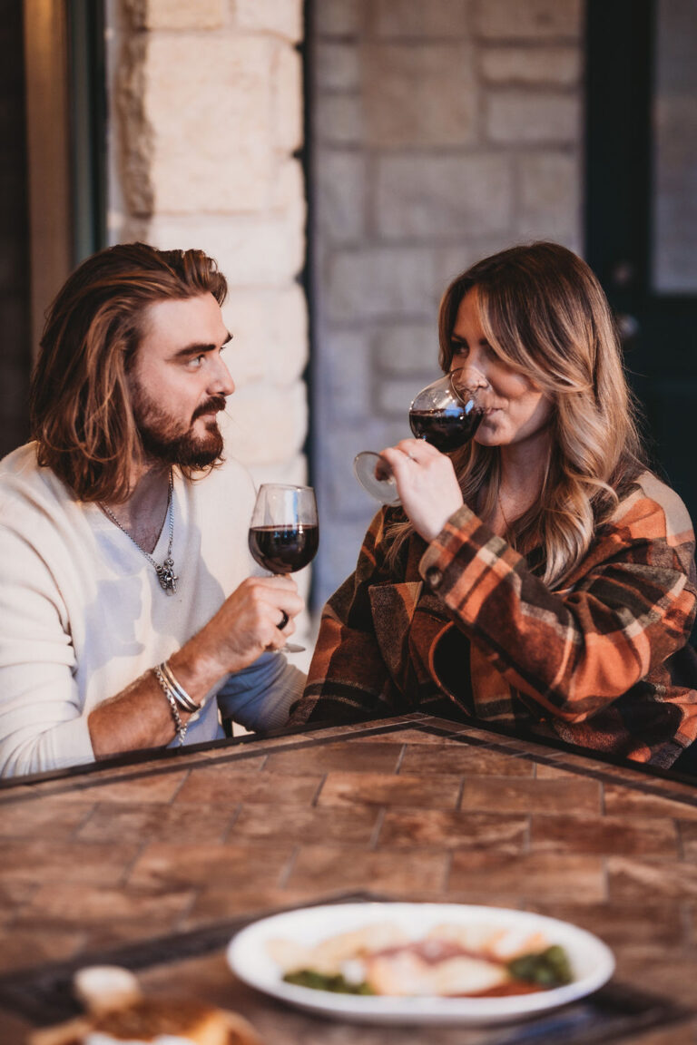 Couple enjoying a romantic evening with a glass of wine at a Wimberley Getaways cottage