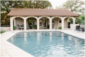 Backyard swimming pool with arched pool house